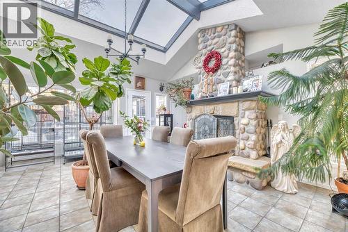 708 Allden Place Se, Calgary, AB - Indoor Photo Showing Dining Room With Fireplace