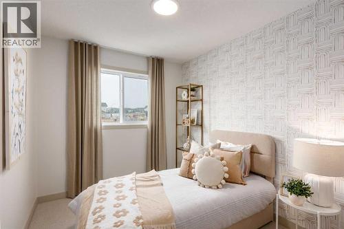 PLEASE NOTE: Photos are of a finished Showhome of the same model – fit and finish may differ on finished spec home. Interior selections and floorplans shown in photos - 129 Raven Link Se, Calgary, AB - Indoor Photo Showing Bedroom