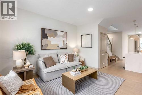 PLEASE NOTE: Photos are of a finished Showhome of the same model – fit and finish may differ on finished spec home. Interior selections and floorplans shown in photos - 129 Raven Link Se, Calgary, AB - Indoor Photo Showing Living Room