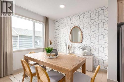 PLEASE NOTE: Photos are of a finished Showhome of the same model – fit and finish may differ on finished spec home. Interior selections and floorplans shown in photos - 129 Raven Link Se, Calgary, AB - Indoor Photo Showing Dining Room