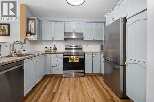 118 Bridleridge Way Sw, Calgary, AB - Indoor Photo Showing Kitchen With Double Sink