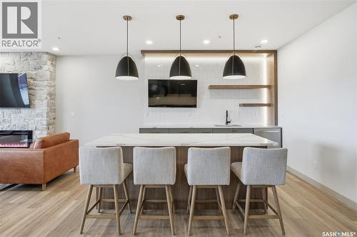 1303 101 Secord Way, Saskatoon, SK - Indoor Photo Showing Dining Room With Fireplace