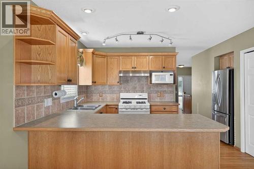 25 Westfall Drive, Okotoks, AB - Indoor Photo Showing Kitchen With Double Sink