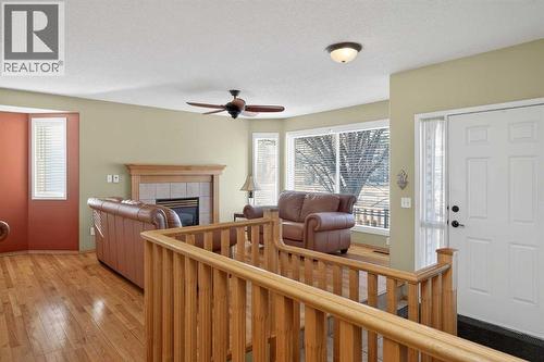 25 Westfall Drive, Okotoks, AB - Indoor With Fireplace