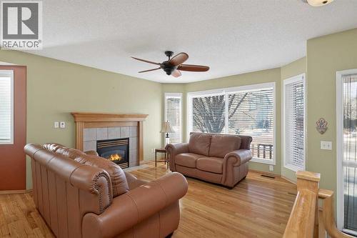 25 Westfall Drive, Okotoks, AB - Indoor Photo Showing Living Room With Fireplace
