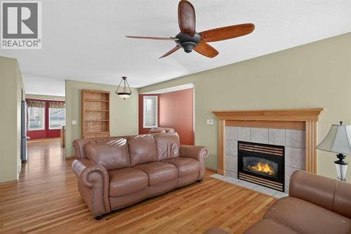25 Westfall Drive, Okotoks, AB - Indoor Photo Showing Living Room With Fireplace