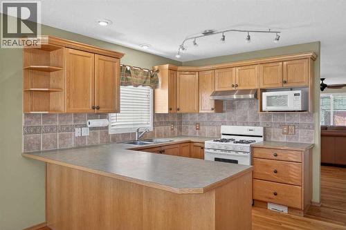 25 Westfall Drive, Okotoks, AB - Indoor Photo Showing Kitchen With Double Sink