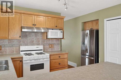 25 Westfall Drive, Okotoks, AB - Indoor Photo Showing Kitchen With Double Sink