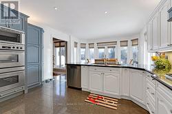 Kitchen open to dinette, with views of outdoors - 