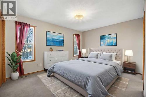 Primary Bedroom - Virtually Staged - 220 Sunset Place, Okotoks, AB - Indoor Photo Showing Bedroom