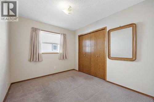 Bedroom 2 - 220 Sunset Place, Okotoks, AB - Indoor Photo Showing Other Room