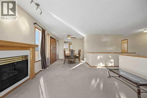 Living Room - 220 Sunset Place, Okotoks, AB - Indoor With Fireplace