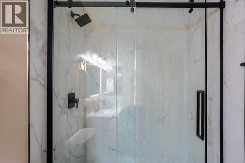 Updated main floor bathroom comes complete with a gorgeous tile surround shower with 10mm glass - 467 Berkley Crescent Nw, Calgary, AB - Indoor Photo Showing Bathroom