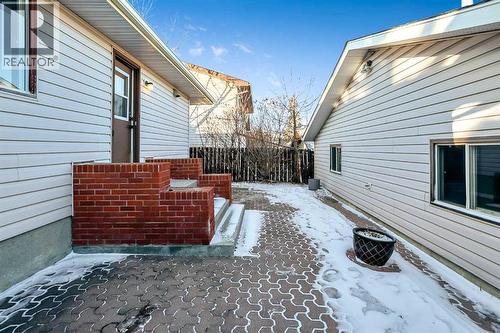 Low maintenance landscaping with a large patio space and a RARE Triple car garage with heat! - 467 Berkley Crescent Nw, Calgary, AB - Outdoor With Exterior