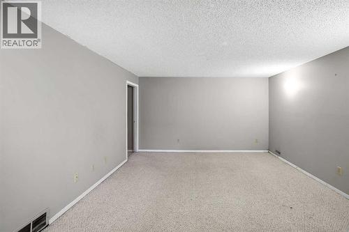 Fully finished basement with a rec room, 4th bedroom, 4pc bathroom, flex room (previously set up as a hair studio) and laundry room with storage - 467 Berkley Crescent Nw, Calgary, AB - Indoor Photo Showing Other Room