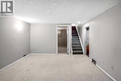 Fully finished basement with a rec room, 4th bedroom, 4pc bathroom, flex room (previously set up as a hair studio) and laundry room with storage - 