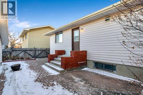 Low maintenance landscaping with a large patio space and a RARE Triple car garage with heat! - 467 Berkley Crescent Nw, Calgary, AB - Outdoor With Exterior