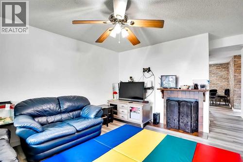 48 Templeridge Crescent Ne, Calgary, AB - Indoor Photo Showing Living Room With Fireplace