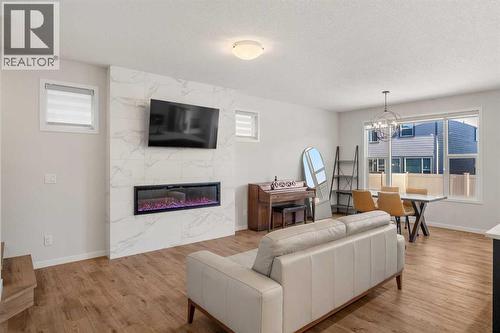 40 West Grove Link Sw, Calgary, AB - Indoor Photo Showing Living Room With Fireplace