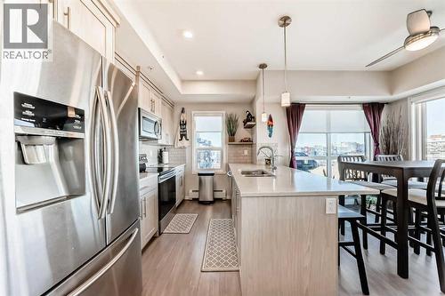 409, 4150 Seton Drive Se, Calgary, AB - Indoor Photo Showing Kitchen With Double Sink With Upgraded Kitchen