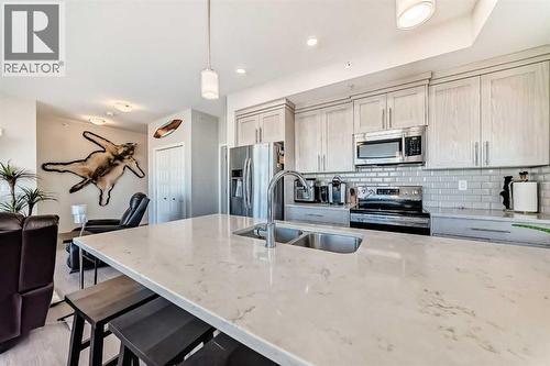 409, 4150 Seton Drive Se, Calgary, AB - Indoor Photo Showing Kitchen With Double Sink With Upgraded Kitchen