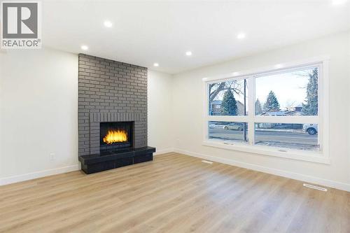 Living room - 14668 Deer Run Drive Se, Calgary, AB - Indoor Photo Showing Living Room With Fireplace