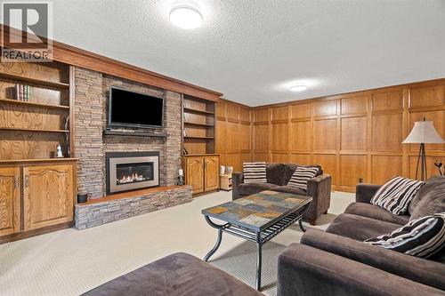 124 Canterbury Drive Sw, Calgary, AB - Indoor Photo Showing Living Room With Fireplace