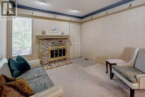76 Edgeland Road Nw, Calgary, AB - Indoor Photo Showing Living Room With Fireplace