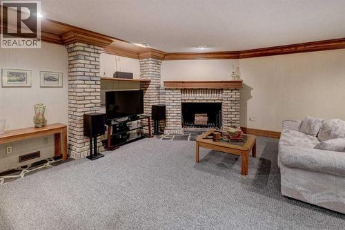 76 Edgeland Road Nw, Calgary, AB - Indoor Photo Showing Living Room With Fireplace