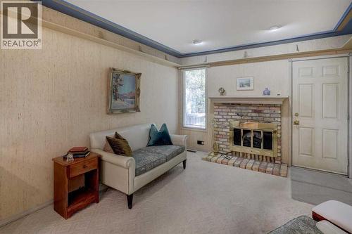 76 Edgeland Road Nw, Calgary, AB - Indoor Photo Showing Living Room With Fireplace