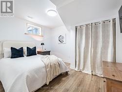 Additional bedroom in basement with laminate - 