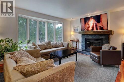 82 Gladys Ridge Road Sw, Calgary, AB - Indoor Photo Showing Living Room With Fireplace