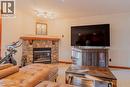 313, 170 Crossbow Place, Canmore, AB  - Indoor Photo Showing Living Room With Fireplace 