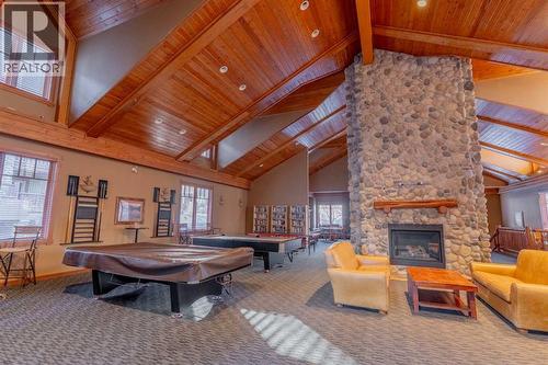 313, 170 Crossbow Place, Canmore, AB - Indoor Photo Showing Other Room With Fireplace