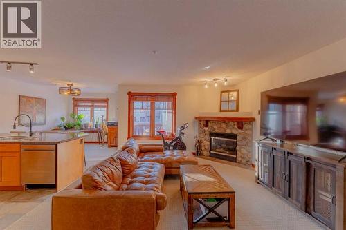 313, 170 Crossbow Place, Canmore, AB - Indoor Photo Showing Living Room With Fireplace