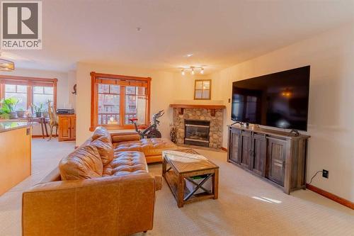 313, 170 Crossbow Place, Canmore, AB - Indoor Photo Showing Living Room With Fireplace