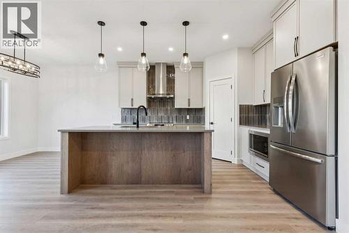 120 Quartz Crescent, Cochrane, AB - Indoor Photo Showing Kitchen With Upgraded Kitchen