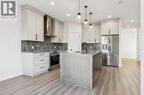 120 Quartz Crescent, Cochrane, AB - Indoor Photo Showing Kitchen With Upgraded Kitchen