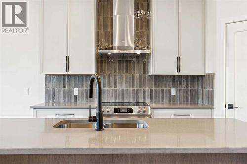 120 Quartz Crescent, Cochrane, AB - Indoor Photo Showing Kitchen With Double Sink With Upgraded Kitchen