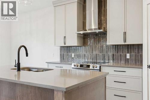 120 Quartz Crescent, Cochrane, AB - Indoor Photo Showing Kitchen With Double Sink With Upgraded Kitchen