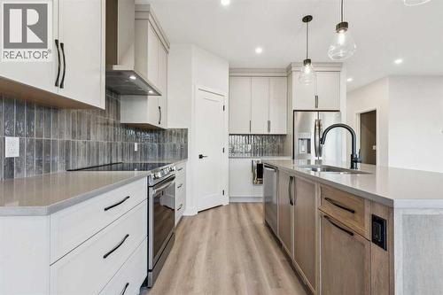 120 Quartz Crescent, Cochrane, AB - Indoor Photo Showing Kitchen With Upgraded Kitchen