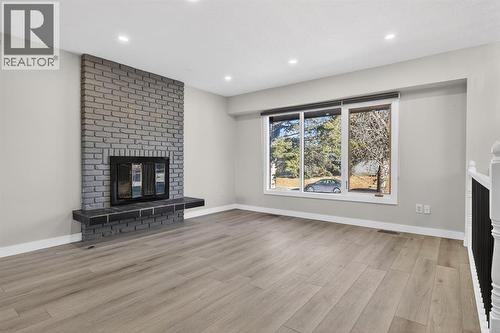 255 Rundleridge Drive Ne, Calgary, AB - Indoor Photo Showing Living Room With Fireplace