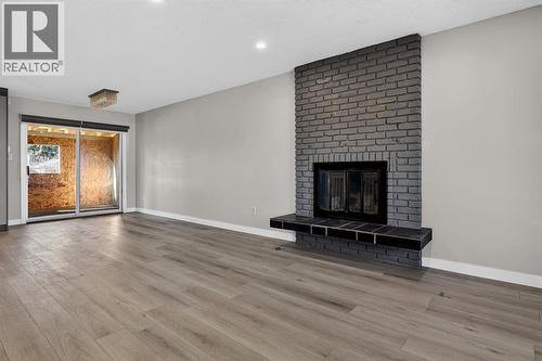 255 Rundleridge Drive Ne, Calgary, AB - Indoor Photo Showing Living Room With Fireplace