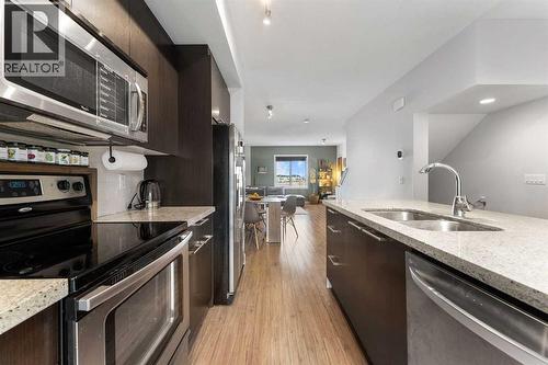 39 Silverado Way Sw, Calgary, AB - Indoor Photo Showing Kitchen With Stainless Steel Kitchen With Double Sink With Upgraded Kitchen