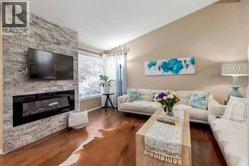 35 Woodstock Road Sw, Calgary, AB - Indoor Photo Showing Living Room With Fireplace