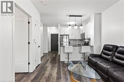 Living area with dark wood-type flooring - 