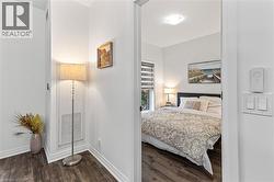 Bedroom featuring dark wood-style floors and baseboards - 