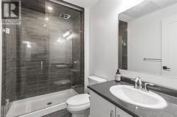 Bathroom with vanity and a shower stall - 
