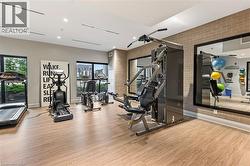 Exercise room with wood finished floors and brick wall - 