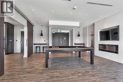 Playroom with billiards table, wood finished floors, wallpapered walls, and recessed lighting - 